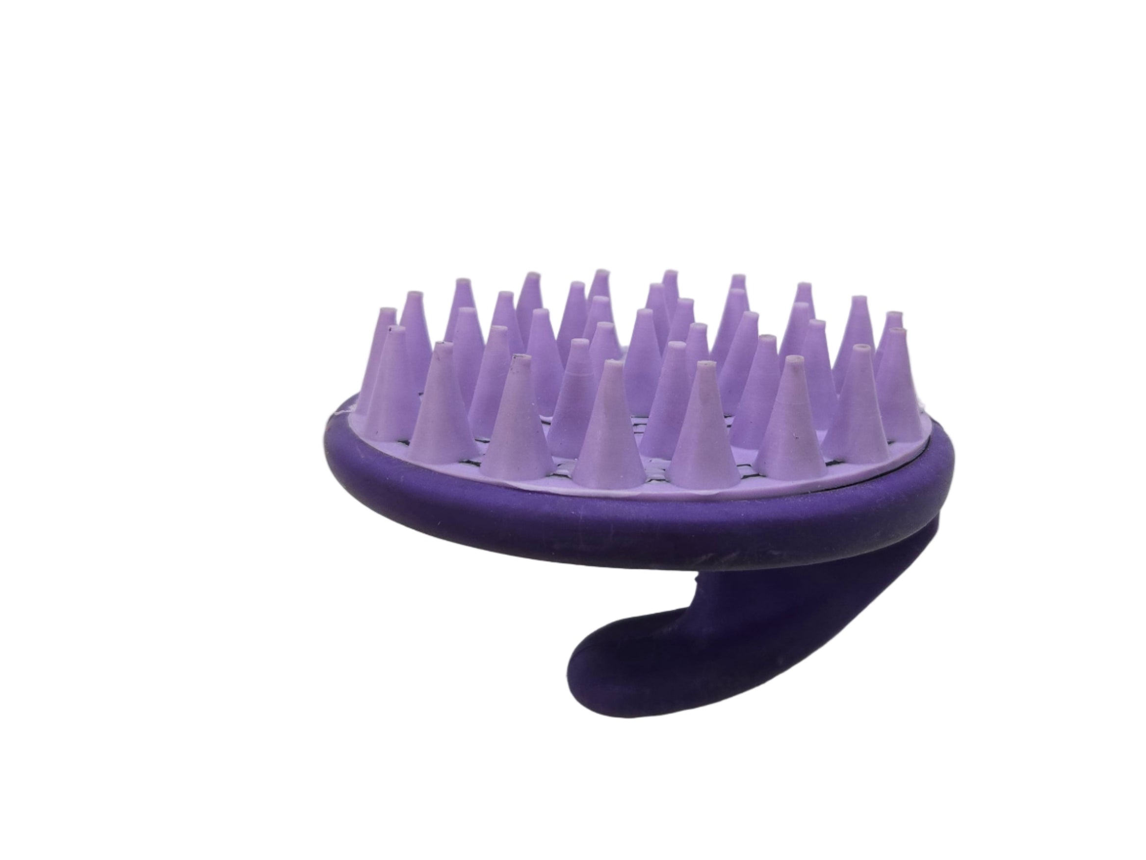 Purple grooming tool with bristles on a white surface